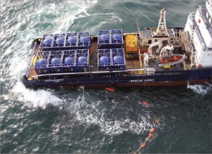 IMG_0272 (2) (2)_fmt A boat using “slider tanks” transports cuttings to shore for further treatment and disposal in the North Sea. The cuttings were blown from a rig without the use of a crane. A transfer line floats in the water.