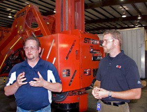 Craig Brooks (left), NOV drillfloor tools product line manager, and Brian Winter, NOV global product engineer, explain the features of the ST-120 iron roughneck during a demo for Drilling Contractor on 29 September in Houston.