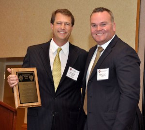 Scott Gordon, regional vice president of Unit Texas Drilling, accepting his 2010 IADC Contractor of the Year award from Jeremy Thigpen, National Oilwell Varco president downhole tools & pumping solutions.