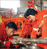 PetroVietnam Drilling workers prepare a wireline tool for deployment. In addition to operating six high-spec jackups, the company also works in partnership with other companies to provide oilfield services.