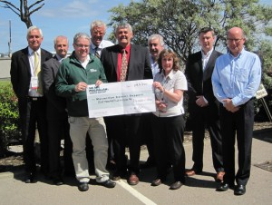 David Cameron (front left in green) of Macmillan Cancer Support accepts a donation check from representatives of the IADC North Sea Chapter: (from left) John Skeggs, Odfjell Drilling; Gary Holman, Archer; Jens Hoffmark, IADC; Glenn White, Rowan Drilling and NSC chairman; Dusty Miller, Diamond Offshore; Edit McLeod, NSC staff; Rob O’Neill, Workstrings International; and Martin Ellins, KCA DEUTAG.