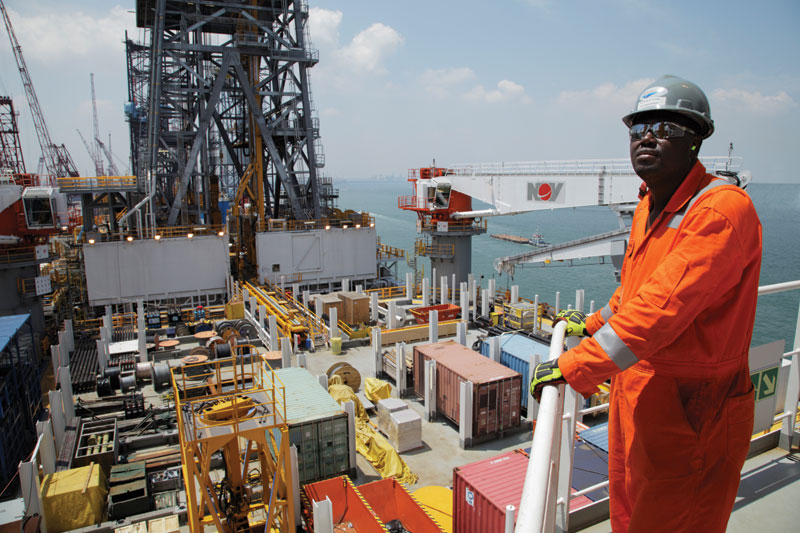 An Ensco rig manager overlooks the riser deck of the ENSCO DS-6 as it under...