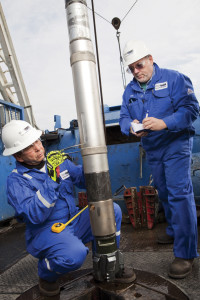 Schlumberger engineers inspect the iPZIG tool prior to drilling in a North American shale play. The service features an azimuthal gamma ray and an inclination measurement behind the bit to give an indication of the BHA position relative to the formation. Photo courtesy of Schlumberger