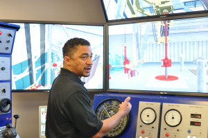 Paul Kilchrist, drilling and well control adviser, demonstrates the capabilities of the conventional drilling simulator during a DC-exclusive tour of the Noble NEXT Center in September. 