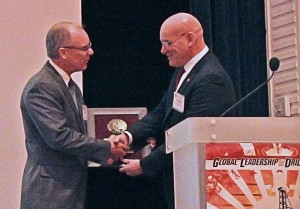 Terry Loftis accepts the IADC Exemplary Service Award for innovation and contributions to the ART Drilling Control Systems Subcommittee from Stephen Colville, IADC president and CEO.