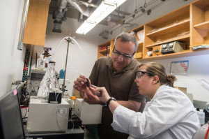 Rice University chemist Andrew Barron and graduate student Brittany Oliva-Chatelain investigate the prototype of the device that allows for rapid testing of nanotracers for the evaluation of wells subject to hydraulic fracturing. Courtesy of Jeff Fitlow/Rice University.
