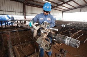 An electromagnetic inspection is performed on used drill pipe. The inspection process uses a buggy unit, which has eight shoes that house coil-induced probes to detect flaws in the tube. The unit scans normal weight drill pipe from upset to upset, the areas of the drill pipe tube that are thicker so the tool joints can be welded onto the pipe.