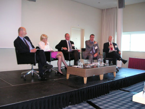 Joe Hurt (right) moderates a panel session at the 2011 IADC Drilling HSE Europe Conference focused on organizational culture and process safety. 